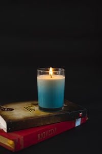 Close-up of illuminated tea light candles on table