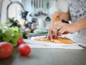 Midsection of woman preparing food at home