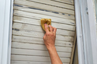 Cropped image of hand holding shutter