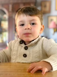 Portrait of cute boy on table