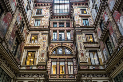 Inside a shopping mall in rome, italy. low angle view of beautiful building interior. 