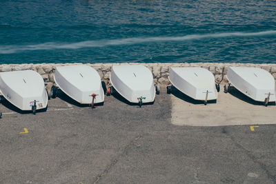 Deck chairs on beach against sky