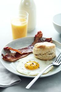 Basic breakfast egg bacon biscuit with orange juice