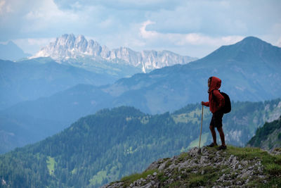 Man standing on mountain against sky