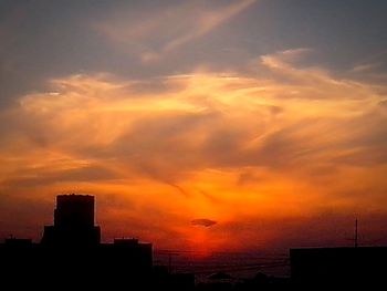 Silhouette of built structure at sunset