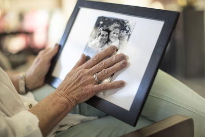 Close-up of senior woman holding a photograph