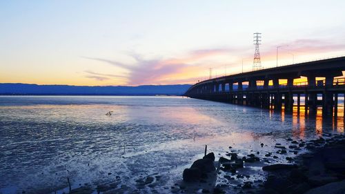 Pier on sea at sunset