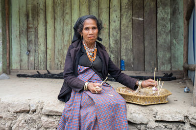 Portrait of man sitting outdoors