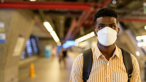 Portrait of young man wearing mask standing outdoors