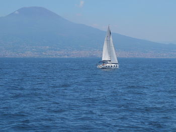 Sailboat sailing on sea against sky