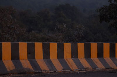 Empty road against trees