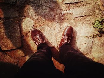 Low section of man standing on rock