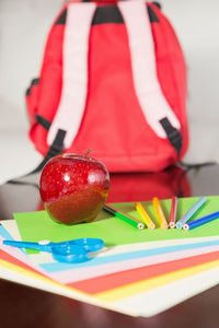 Midsection of person with red berries on table