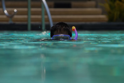 Man swimming in pool