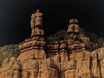 Low angle view of rock formation against sky