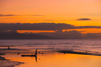 Scenic view of sea against orange sky