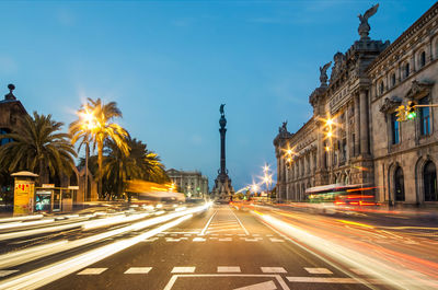 Light trails on city street at dusk