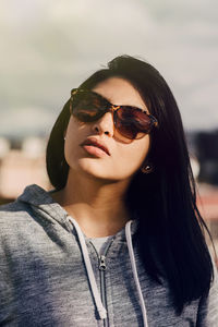 Close-up portrait of young woman wearing sunglasses