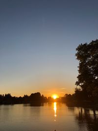 Scenic view of lake against sky during sunset