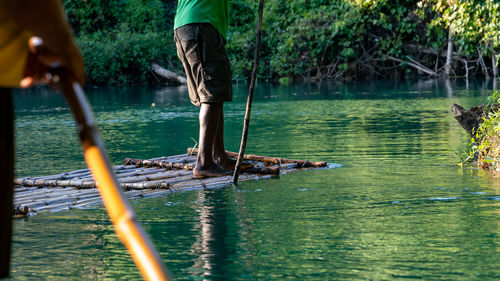 Rear view of man standing in lake