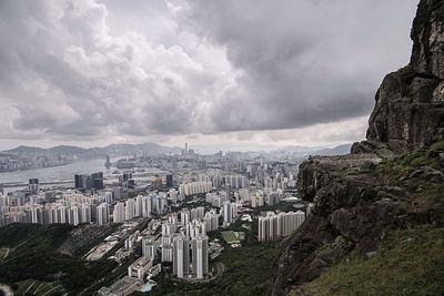 Cityscape against cloudy sky