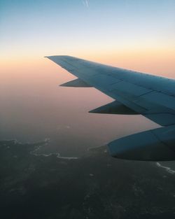 Cropped image of airplane flying over landscape