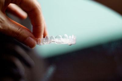 Close-up of woman holding denture