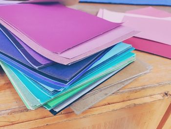 High angle view of colorful pencils papers on table