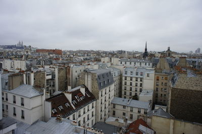 Cityscape against cloudy sky