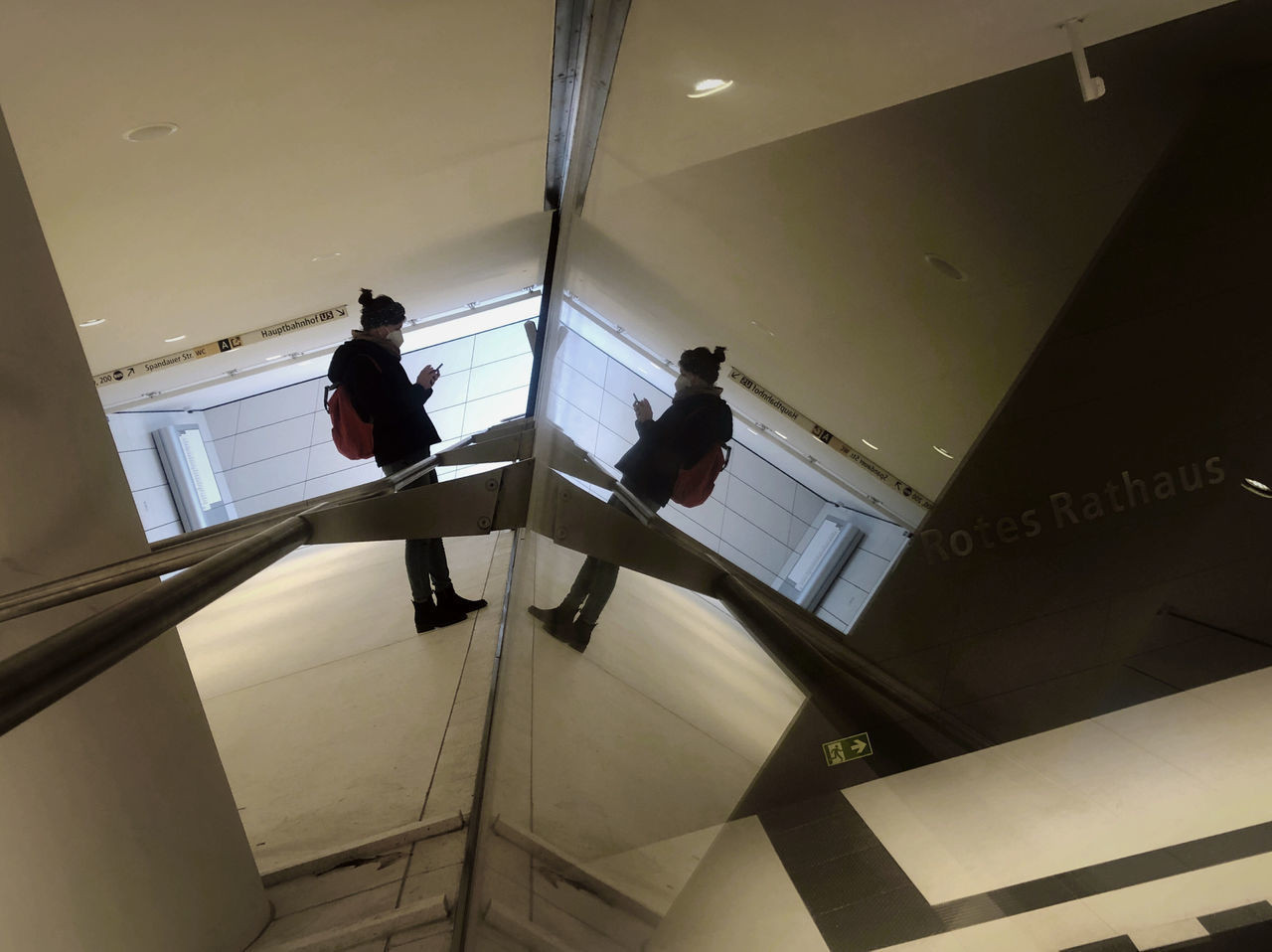 LOW ANGLE VIEW OF PEOPLE WALKING ON STAIRCASE OF BUILDING