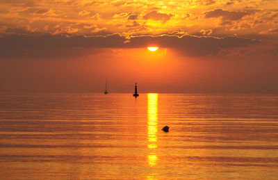 Scenic view of calm sea at sunset