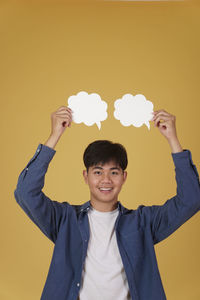 Portrait of a young man against gray background