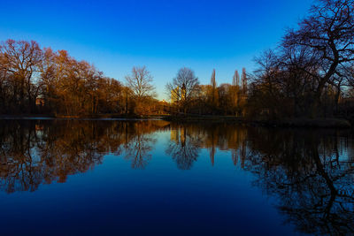 Scenic view of lake against clear blue sky