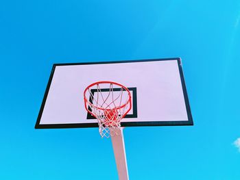 Low angle view of basketball hoop against blue sky