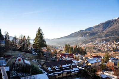 Houses in town against clear sky