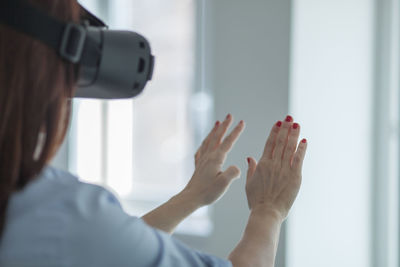 Mature woman using virtual reality simulator