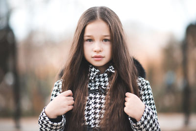 Portrait of kid girl 10-12 year old with long blonde hair wear casual jacket in park outdoor