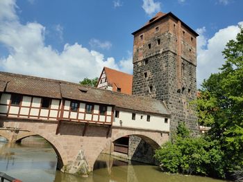 Low angle view of arch bridge and building against sky