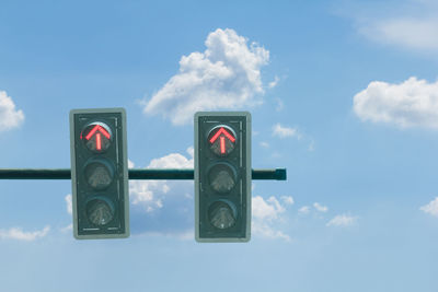 Low angle view of road sign against sky