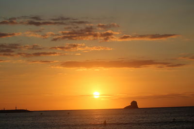 Scenic view of sea against romantic sky at sunset