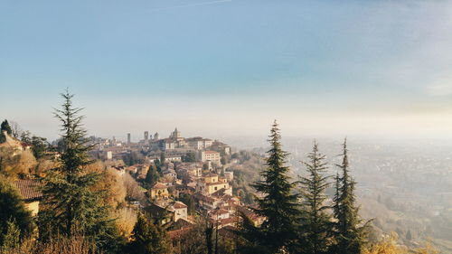 High angle view of trees and buildings against sky