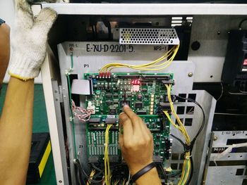 Close-up of hand working on cable car