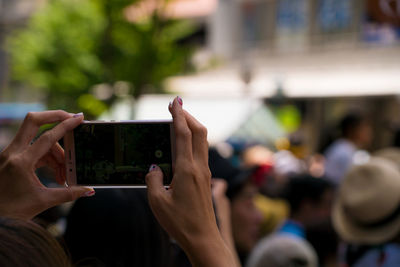 Close-up of hand holding mobile phone