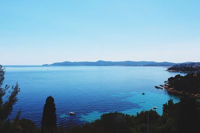 Scenic view of sea against clear blue sky