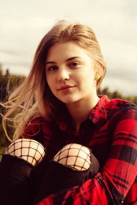 Portrait of beautiful woman sitting outdoors