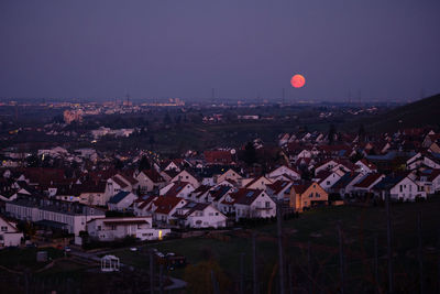 Homes houses with red moon in the dawn