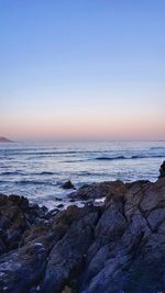 Scenic view of sea against clear sky during sunset