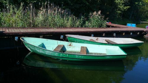 Two boats moored on lake