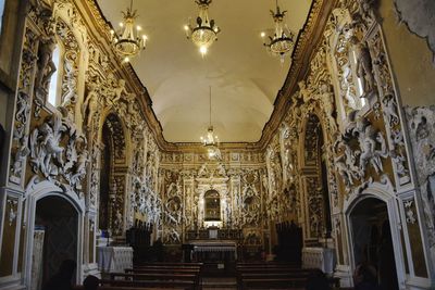 Low angle view of illuminated chandelier in building chapelle s. anna