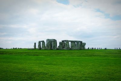 Large group of people walking towards stonehenge